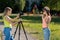 Two girls teenager girlfriend. Summer in nature. Writes the video to the camera. In sunglasses and a hat. Use camera