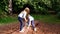 Two girls teetering on an unstable log, playing in the park. active games.