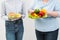 Two girls, thick and thin, with healthy food from vegetables and fruits and unhealthy fast food with a hamburger. The