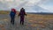 Two girls - tourists with backpacks and trekking poles go hiking. Trekking in Klyuchevskoy volcano park.