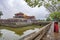 Two girls in traditional cloths and Hue citadel main gate, Vietnam