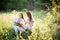 Two girls in Ukrainian national dress sitting on the grass. Girl