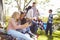 Two Girls Using Mobile Phone On Family Camping Holiday