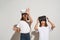 Two girls using virtual reality headset on white