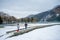 Two Girls Walking on Boardwalk by Lake in Snow