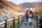 Two girls walking on the street and red yellow maple tree in autumn season, taken from Hokkaido Japan. Beautiful view in