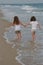 Two Girls walking in the water