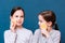 Two girls wash themselves with face sponges on a blue background. Child Hygiene Concept