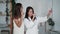 Two girls in white bathrobe dance, sing, laugh, make selfie on phone, funny video