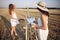 Two girls in a white dress painting in a field