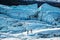 Two glacier guides walking among large crevasses and seracs on top of the Matanuska Glacier in Alaska