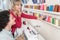 Two glad women buying sewing supplies