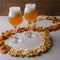 Two glass of beer and beer snacks over white background. Potato chips and popcorn shaped like an 8.