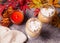 Two glass of hot creamy cocoa with froth with autumn leaves and candle on the background