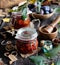 Two glass jars with homemade canned plums jam, marmalade, jelly on rustic wooden table with cardamon, cinnamon,  anise