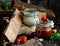 Two glass jars with homemade red and white sauces for barbecue with herbs, cherry tomatoes, garlic, pepper