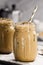 Two Glass Jars with Iced Coffee with Milk