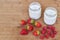 Two glass jars with yogurt, raspberries and strawberries horizontal high angle view.