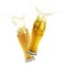 Two glasses of beer toasting with splash on white background