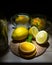 Two glasses and a bottle with drinks and fruits, lemons and oranges, mint on a wooden table