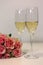 Two glasses of champagne and a bouquet made of beautiful light red / blush pink roses