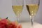 Two glasses of champagne and a bouquet made of beautiful light red / blush pink roses