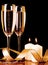 Two glasses with champagne and candles