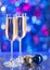 Two glasses of champagne with a Christmas decor in the background. very shallow depth of field, focus on near glass