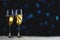 Two Glasses of Champagne Dark Glow Lights Background. Copy Space