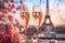 Two glasses of champagne on a table of romantic cafe or restaurant with view to Eiffel tower in Paris, France