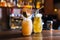 Two glasses of cocktails with dried oranges in bar