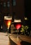 Two glasses with cold beer and cider on wooden cafe table. Dark blur background with copy space