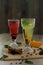 Two glasses with colored hot drinks from which steam comes. winter hot seasonal drinks