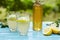 Two glasses of elderflower lemonade and bottle