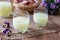 Two glasses of fresh whey with pansy flowers