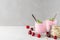 Two glasses of healthy cherry yogurt with fresh berries, oats spoon and mint on white marble table. healthy breakfast
