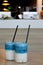 Two glasses of iced pea latte. Blue tea layered cocktail with milk on wooden table with black straw and ice