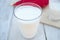 Two glasses of kefir on a white wooden background.