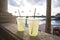 Two glasses of lemonade poolside at a tropical resort