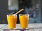 Two glasses of natural smoothie, juice, cocktail, made at home from the pulp of homemade pumpkin, on a blurred background of the