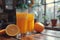 Two glasses of orange juice and oranges on a rustic table