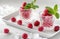 two glasses with raspberries and mint decorate a white tray
