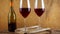 Two glasses of red wine. Alcoholic drink in a glass. A bottle of wine. Wooden background.