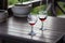 Two glasses of red wine in wooden table. Elegant wine party. Alcoholic drinks. Summer relax with wine. Romance concept.