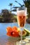 Two glasses of rose bubbles champagne or cava wine served outside on paradise island with palms and green grass