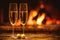 Two glasses of sparkling champagne in front of warm fireplace. C