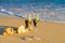 Two glasses in a wave of the sea on the beach