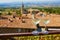 Two glasses of white wine with view to beautiful old roofs of Bonnieux village in France