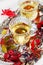 Two glasses of white wine on a vintage silver tray decorated with autumn grape, leaves and raspberries, romantic picnic