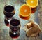 Two glasses of wine and pieces of orange, photo in vintage style